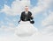 Businessman sitting on a cloud