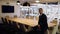 Businessman sitting on conference table alone in empty office