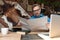 Businessman sitting at desk and reading the newspaper happy