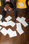 Businessman sitting with head in hands, documents scattered on floor