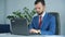 Businessman Sitting In Office And Typing On Laptop