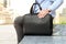 Businessman sitting / resting after working day and holding a leather briefcase in his hand