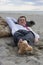 Businessman sleeping on a beach