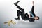 Businessman slipping on a banana peel