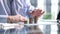 Businessman stacking coins on table, business growth concept. Hand puts coin to stack.