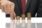 Businessman stacking up coins with some reflection