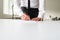 Businessman standing behind his office desk signing a document