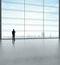 Businessman standing in big sunlight office