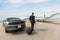 Businessman Standing By Car And Private Jet At