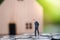 Businessman standing on the coin and stress on no money to installment payment under sunlight with blurred background