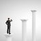 Businessman standing on column