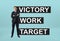 Businessman standing confidently with a motto \'victory work target\' behind him
