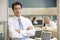 Businessman standing in cubicle