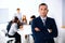 Businessman standing in front of business meeting