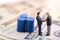 Businessman standing in front of drums oil and shake hand with team. Oil trend down