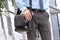 Businessman standing and holding a leather briefcase on his s