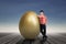 Businessman standing by a huge golden egg