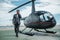 Businessman standing near private helicopter