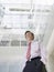 Businessman Standing In Office Atrium