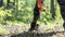 Businessman standing over a green plant in a forested area water