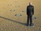 Businessman Standing In Ring At Barren Landscape