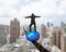 Businessman standing on top of ball balancing on wire