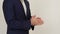 Businessman stands and gesticulation by hands.