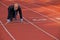 Businessman at the start line of running track