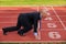 Businessman at the start line of running track