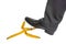 Businessman stepping on banana peel - business risk concept