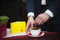 Businessman stirring dark coffee on a table