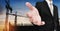 Businessman stretch out hand, with silhouette building construction site in sunrise background