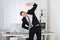 Businessman Stretching In Office