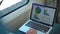 Businessman studying graphs on his laptop in a train