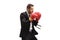 Businessman in a suit with boxing gloves in a guard position