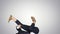 Businessman in suit does break dance moves on gradient background.