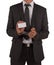 Businessman in suit and handcuffs showing card