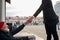 Businessman in suit hold out his hand to beggar man