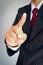 Businessman in suit showing gesture point something