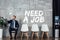 Businessman in suit showing idea gesture and sitting in waiting hall with need a job lettering