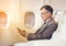 Businessman with suit sitting seat via using smartphone in the airplane