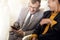 Businessman with suit sitting seat via using smartphone in the airplane