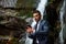 Businessman in suit with smartphone at waterfall background. Waterproof device concept. Telework business man with ip68