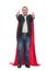 Businessman in suit and superhero red cloak raises hand up, white background
