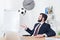 businessman in suit throwing soccer ball at workplace