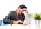 Businessman in suit and tie sitting at office desk working on computer