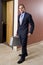 Businessman in suit walking down corridor