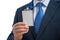 Businessman in suit wearing a blank ID tag or name card on a lanyard at an exhibition or conference