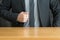 Businessman in suit and wood table