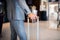 Businessman with suitcase in a hotel entrance hall.